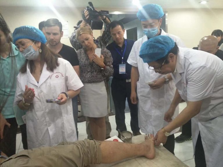 Medical professionals in a clinical acupuncture demonstration